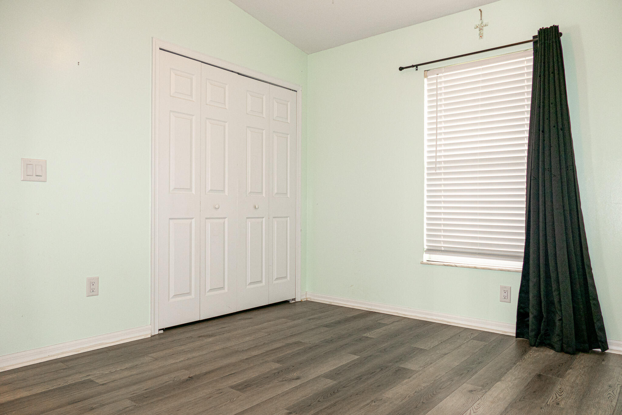 7685 Pleasant Ridge Court Stuart, FL 34997 - Photo 30 of 66 an empty room with wooden floor and a window