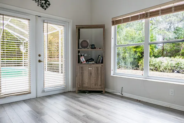 a bathroom with a toilet and a painting on the wall