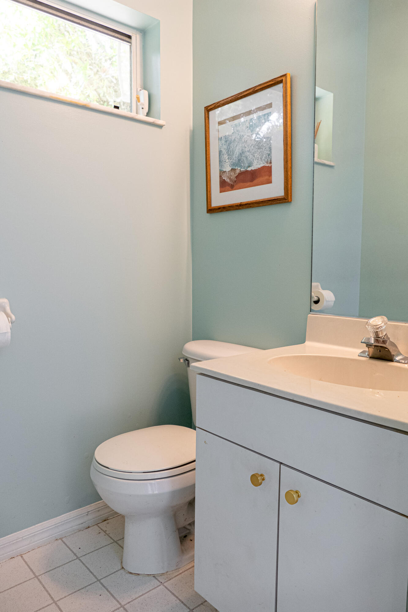 7685 Pleasant Ridge Court Stuart, FL 34997 - Photo 35 of 66 a bathroom with a toilet and a painting on the wall