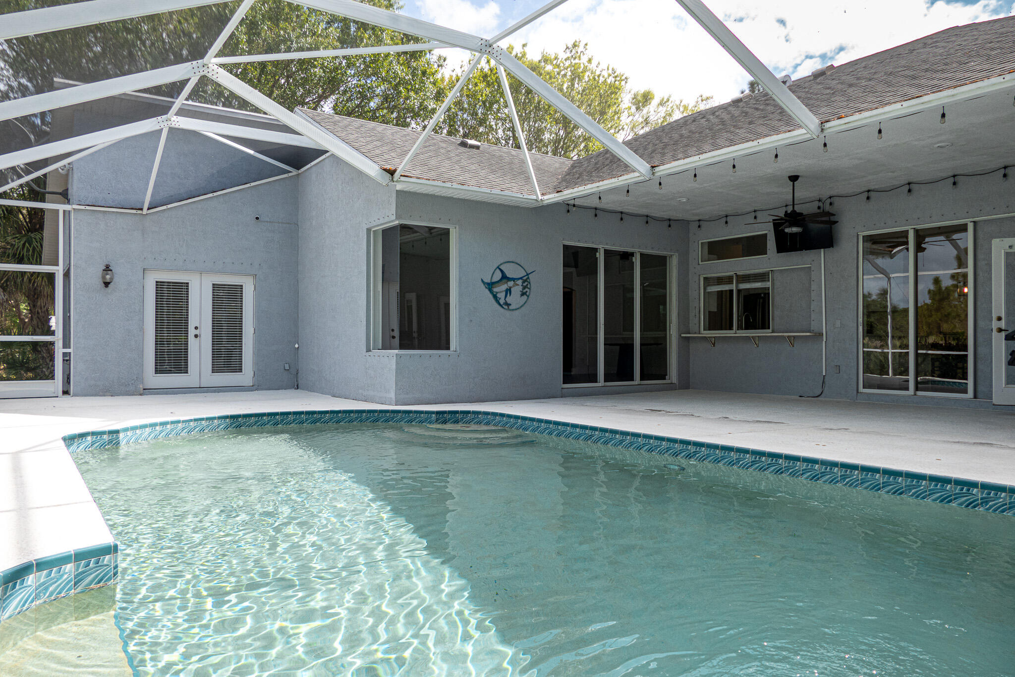 7685 Pleasant Ridge Court Stuart, FL 34997 - Photo 48 of 66 a view of a house with a swimming pool