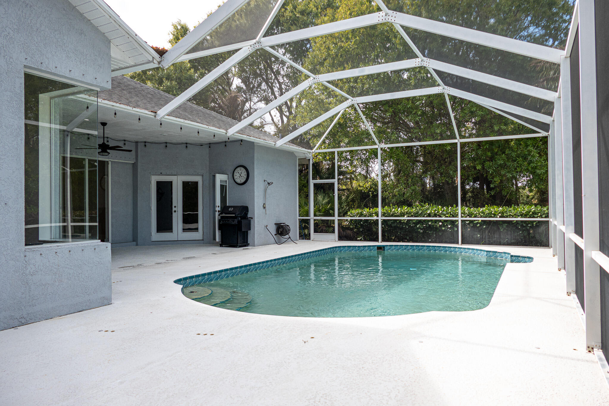 7685 Pleasant Ridge Court Stuart, FL 34997 - Photo 49 of 66 a view of a swimming pool with a porch