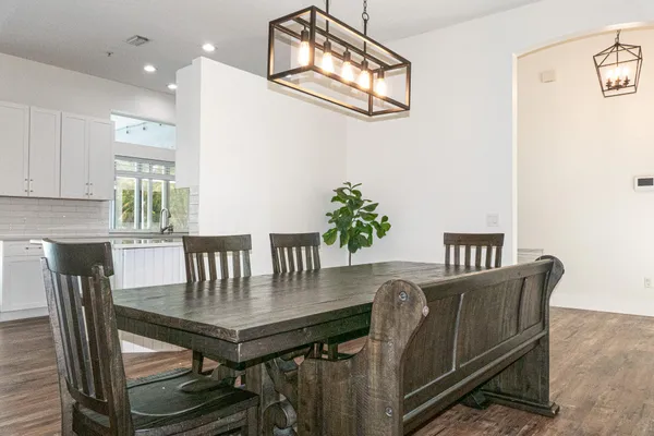 a kitchen with stainless steel appliances granite countertop a refrigerator stove and sink