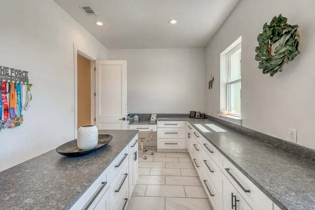 a kitchen with a sink and a stove top oven