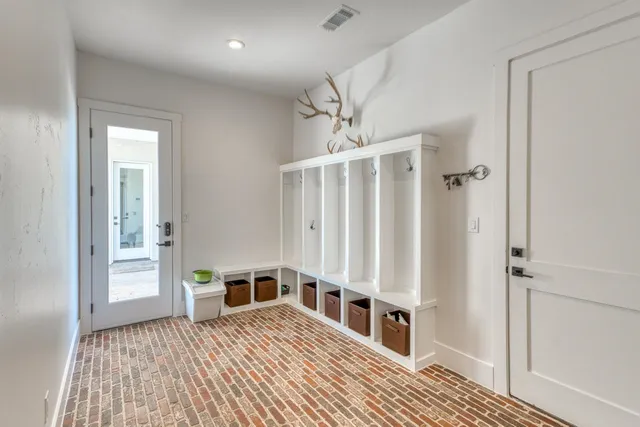 a view of a bedroom with wooden floor