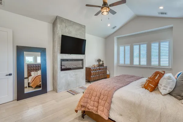 a bedroom with a bed and a television