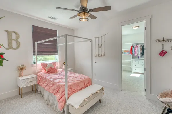 a bedroom with a bed closet and a window