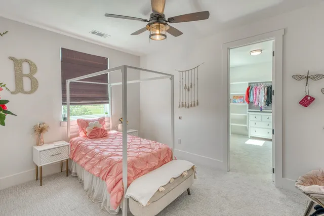 a bedroom with a bed closet and a window