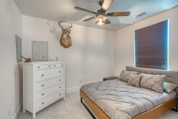a bedroom with a bed and a chandelier