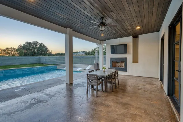 a view of a porch with furniture and a yard