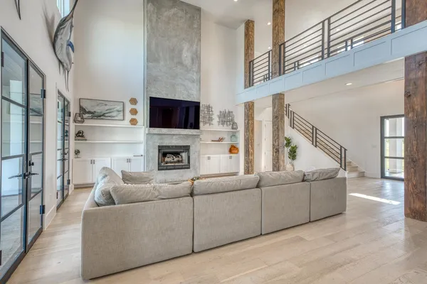 a living room with furniture a flat screen tv and a fireplace