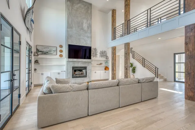 a living room with furniture a flat screen tv and a fireplace