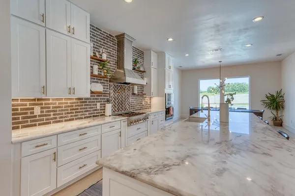 a kitchen with stainless steel appliances granite countertop a stove and cabinets