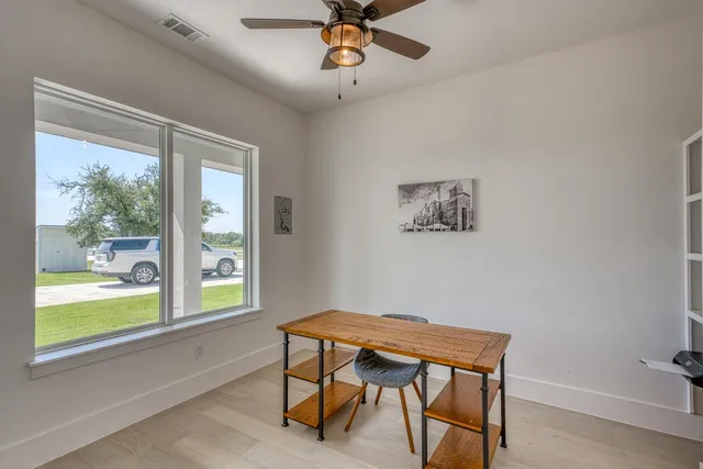 a workspace room with furniture and windows