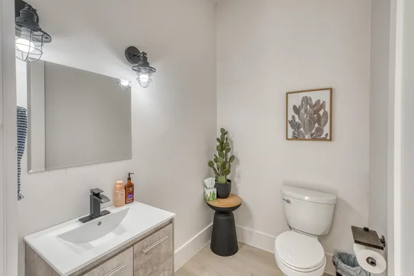a bathroom with a toilet sink and mirror