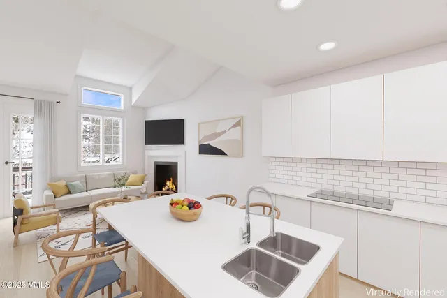 a kitchen with a stove a sink a dining table and chairs