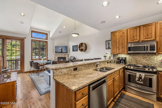 a kitchen that has a sink and a stove in it