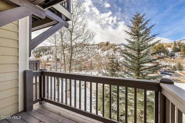 a view of a big house with a big yard and large trees