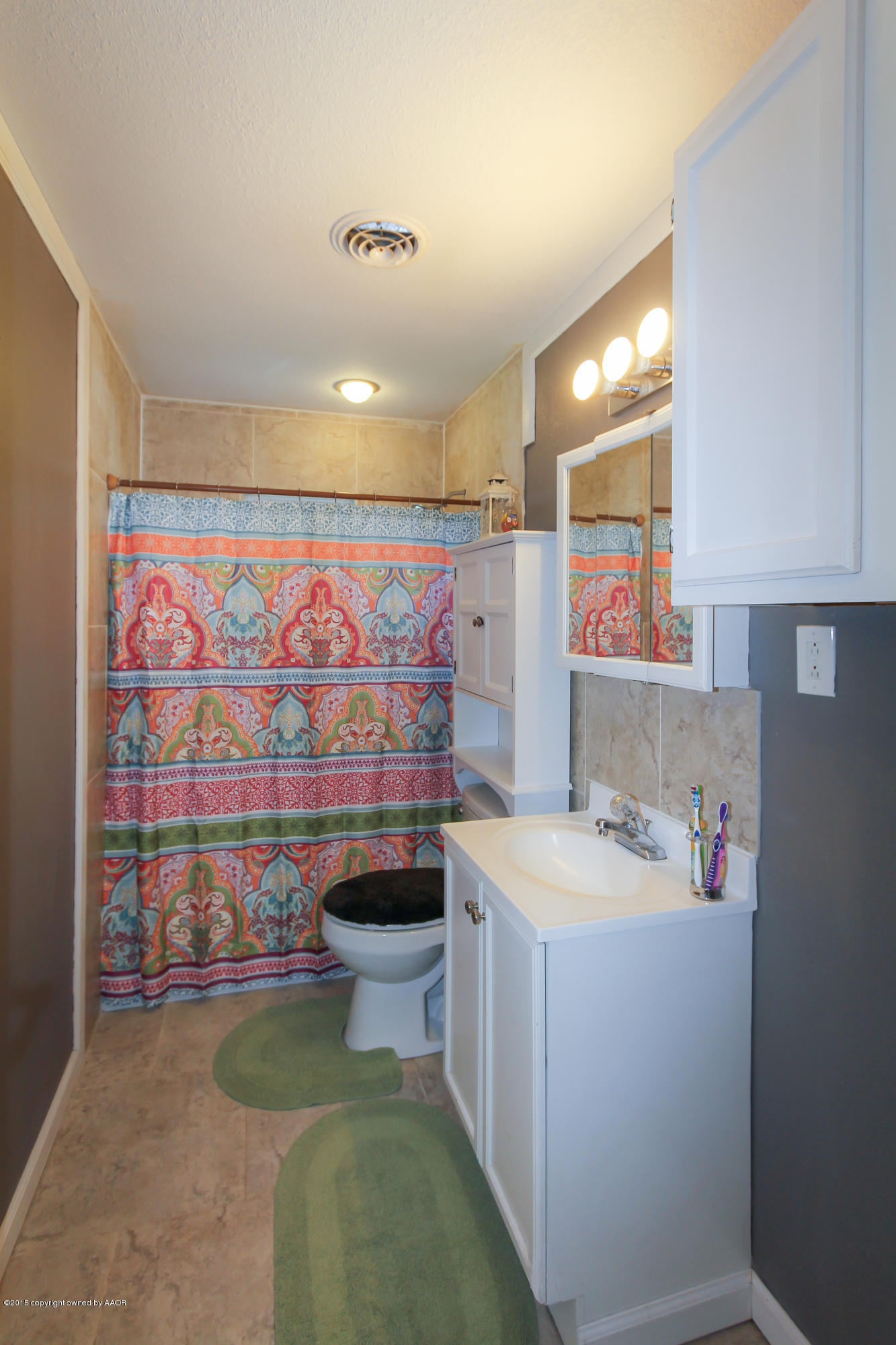 4308 South Monroe Street Amarillo, TX 79110 - Photo 14 of 18 a bathroom with a sink a toilet and shower curtain