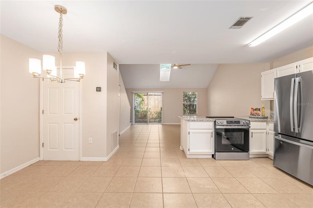 9755 Southwest 52nd Road Gainesville, FL 32608 - Photo 6 of 43 a kitchen with stainless steel appliances a refrigerator sink and stove top oven
