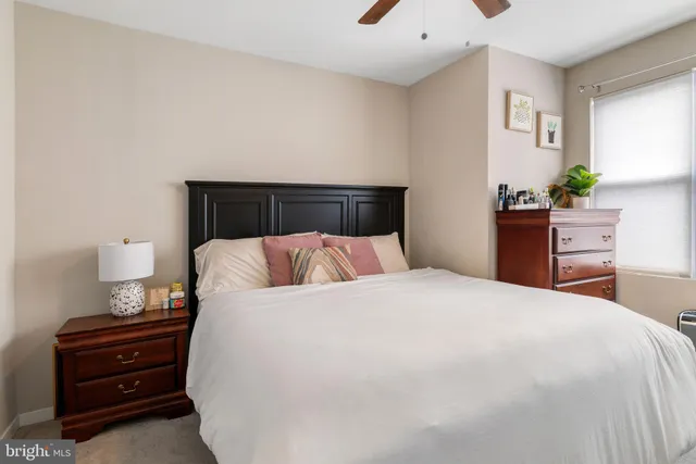 a bedroom with a large bed and a large window