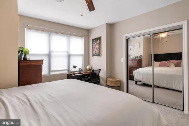 a bedroom with a bed and a large mirror