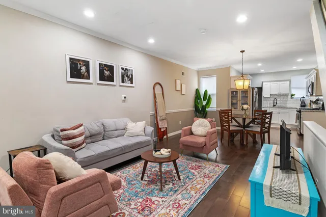 a living room with furniture fireplace and a table