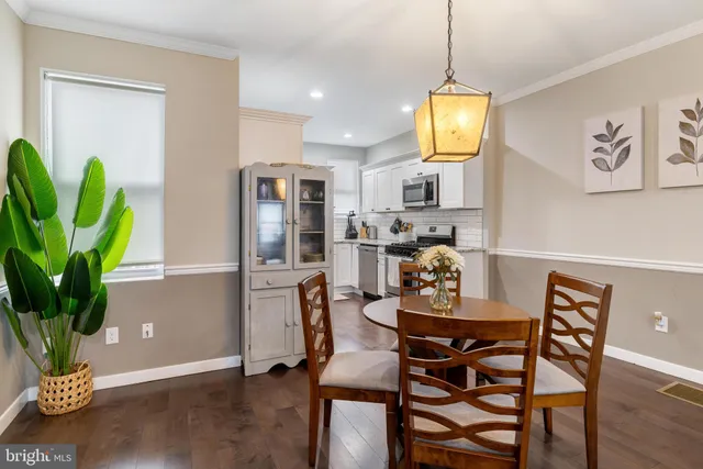 a view of a dining room with furniture and a potted plant