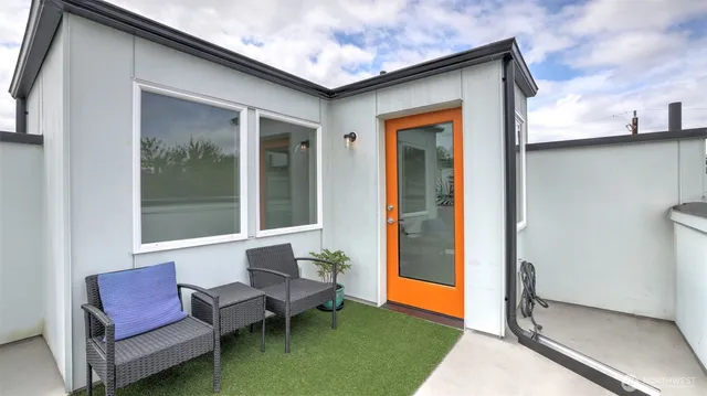 a outdoor living space with furniture and a rug