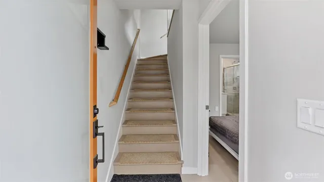 a view of a hallway with wooden floor and entryway