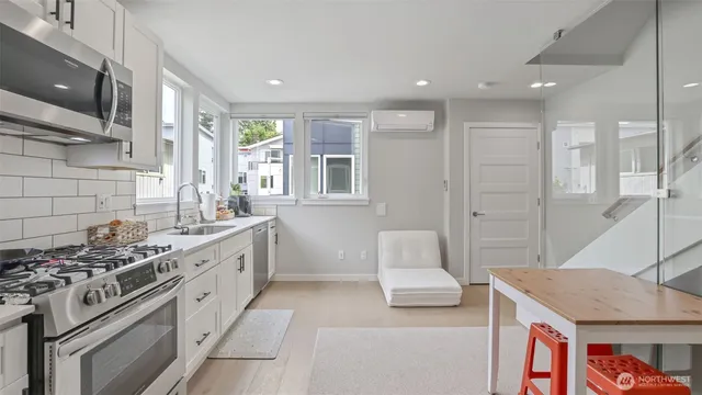 a kitchen with stainless steel appliances granite countertop a stove and a sink