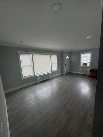 a large kitchen with a stove a sink and a microwave