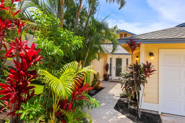 a view of a house with a flower garden