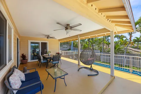 a living room with furniture a chandelier and a dining room