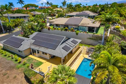 an aerial view of residential houses with outdoor space and swimming pool