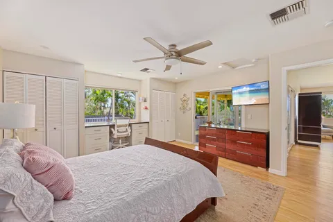 a spacious bathroom with a granite countertop sink mirror and a bathtub