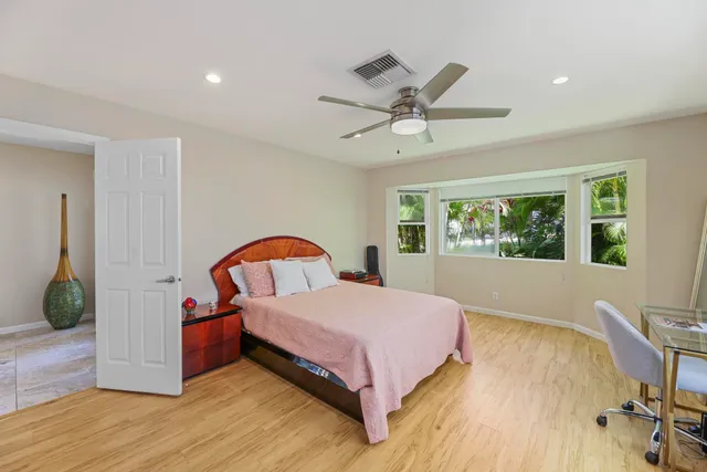 a bedroom with a large bed and a chandelier
