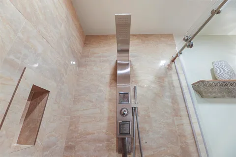 a bathroom with a toilet a sink and shower