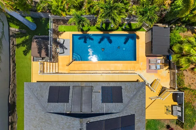 a front view of a house with a tree