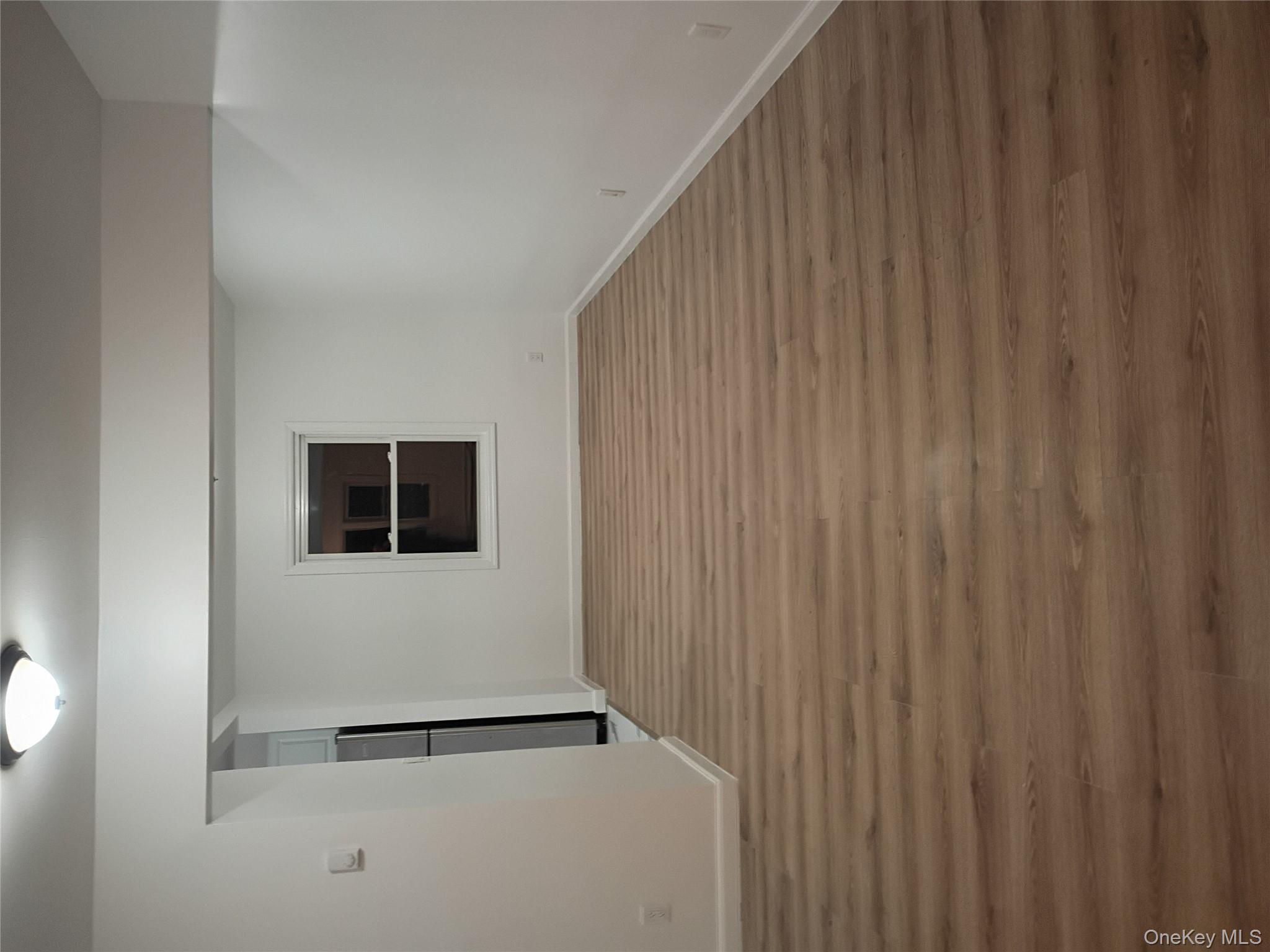 67 Albany Avenue, Unit A&B Flanders, NY 11901 - Photo 3 of 24 Spare room featuring light wood-type flooring