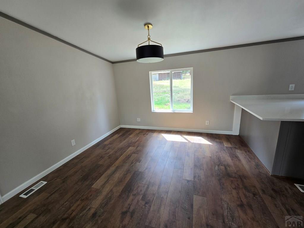 8229 Green Lane Rye, CO 81069 - Photo 8 of 24 an empty room with wooden floor ceiling fan and windows