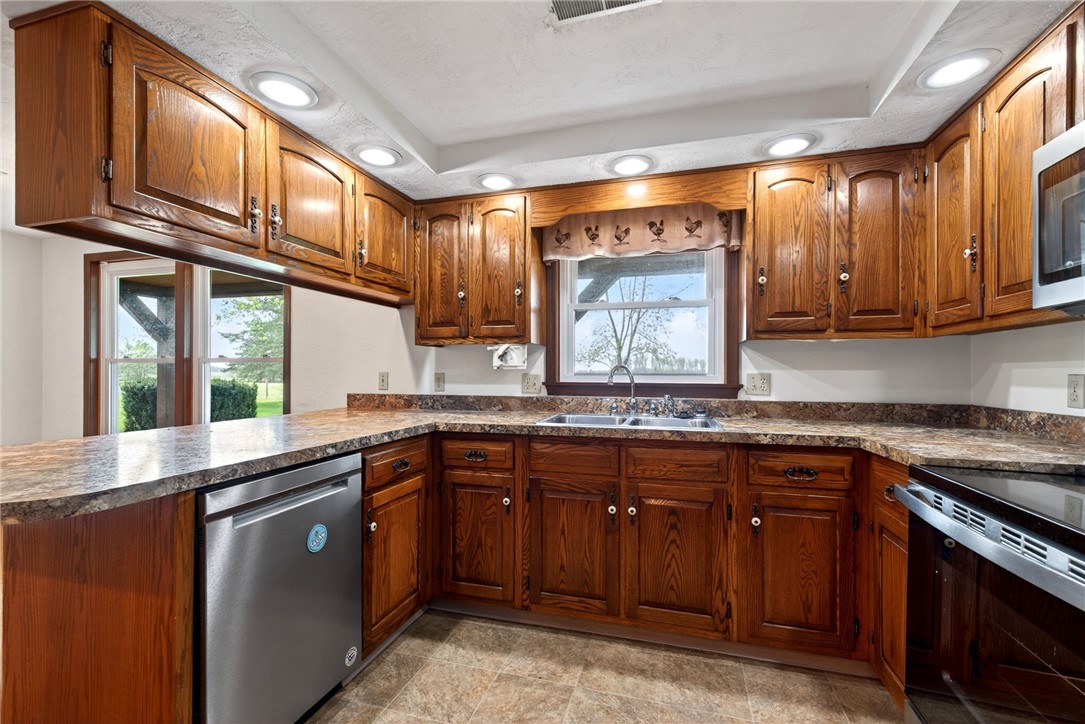 7988 McCool Road Greenville, OH 45331 - Photo 9 of 50 This spacious kitchen offers ample cabinet storage, generous counter space, and modern appliances.