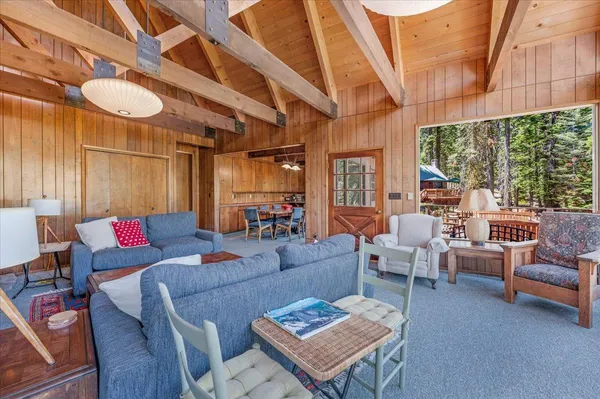 a kitchen that has a sink a refrigerator and cabinets