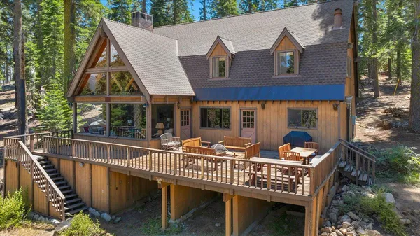 a view of a roof deck with couches and wooden floor