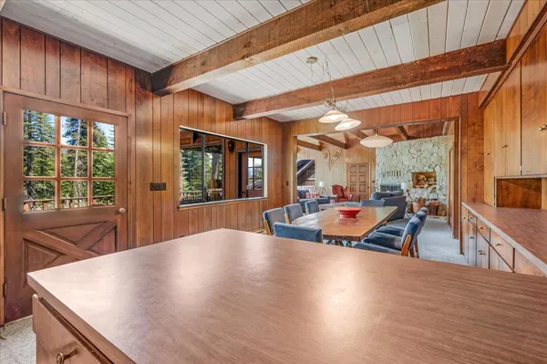 a bedroom with two beds and large windows