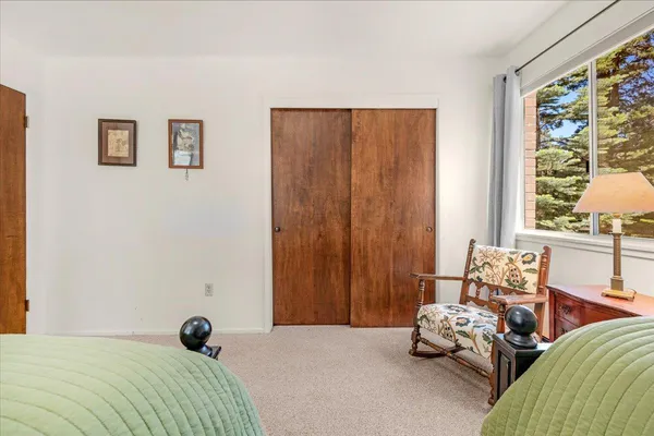 a view of a small space with wooden floor and a window