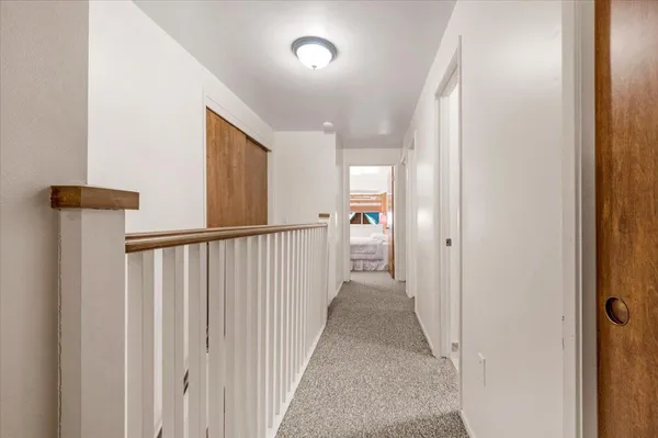 a view of a patio with table and chairs with wooden floor and fence
