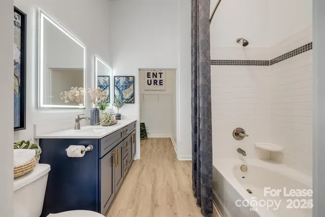 a bathroom with a bathtub sink and mirror