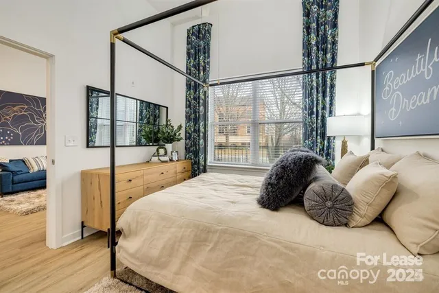 a bedroom with a large bed and a large window