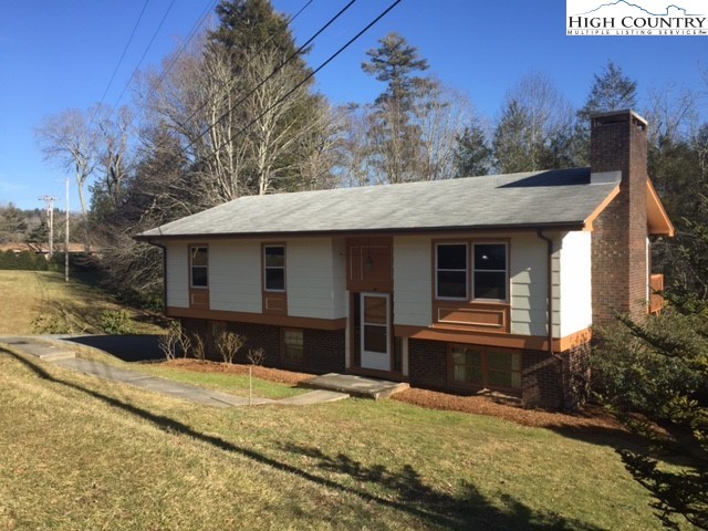 465 Highland Avenue Boone, NC 28607 - Photo 1 of 10 a front view of a house with a yard and garage