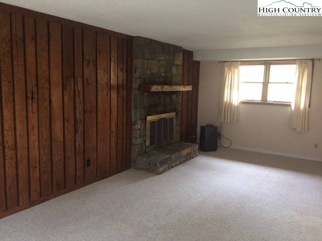 465 Highland Avenue Boone, NC 28607 - Photo 4 of 10 a view of empty room with wooden floor and fireplace